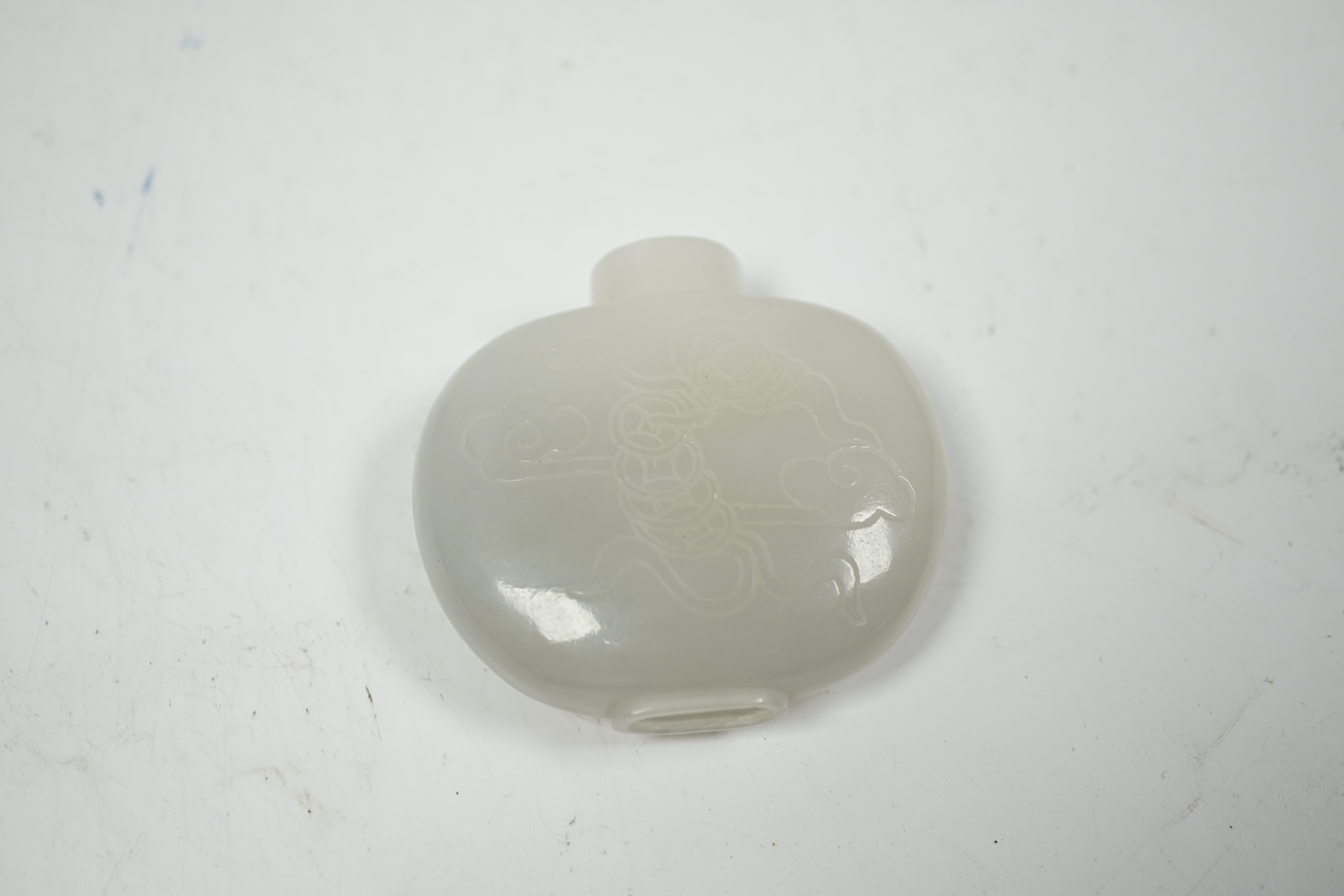 A Chinese white jade ‘chilong’ snuff bottle, 5.5cm wide